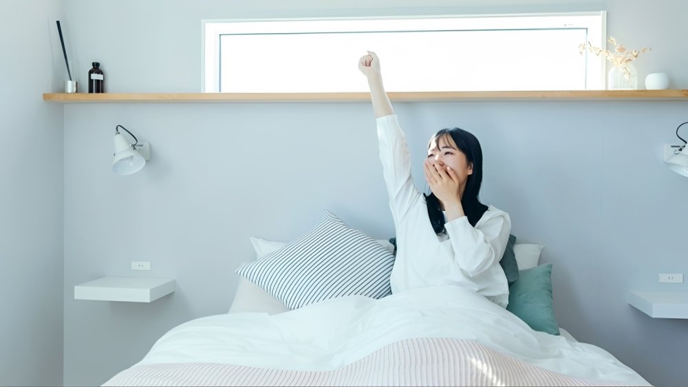 woman-waking-up-in-bright-bedroom (1).jpg