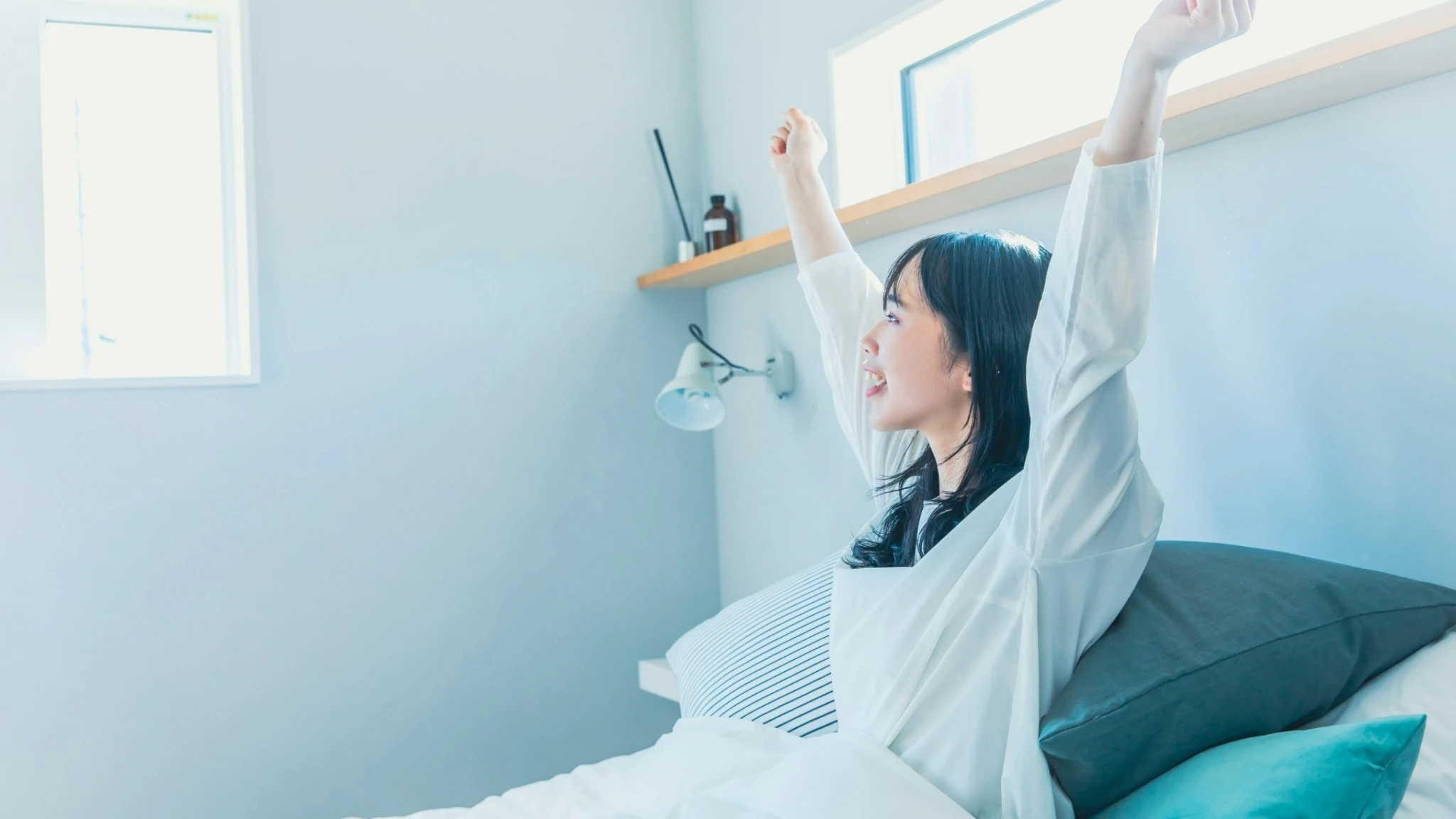 morning-stretch-woman-bedroom.webp